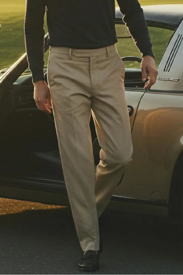 Man stepping out of a vintage car on a golf course