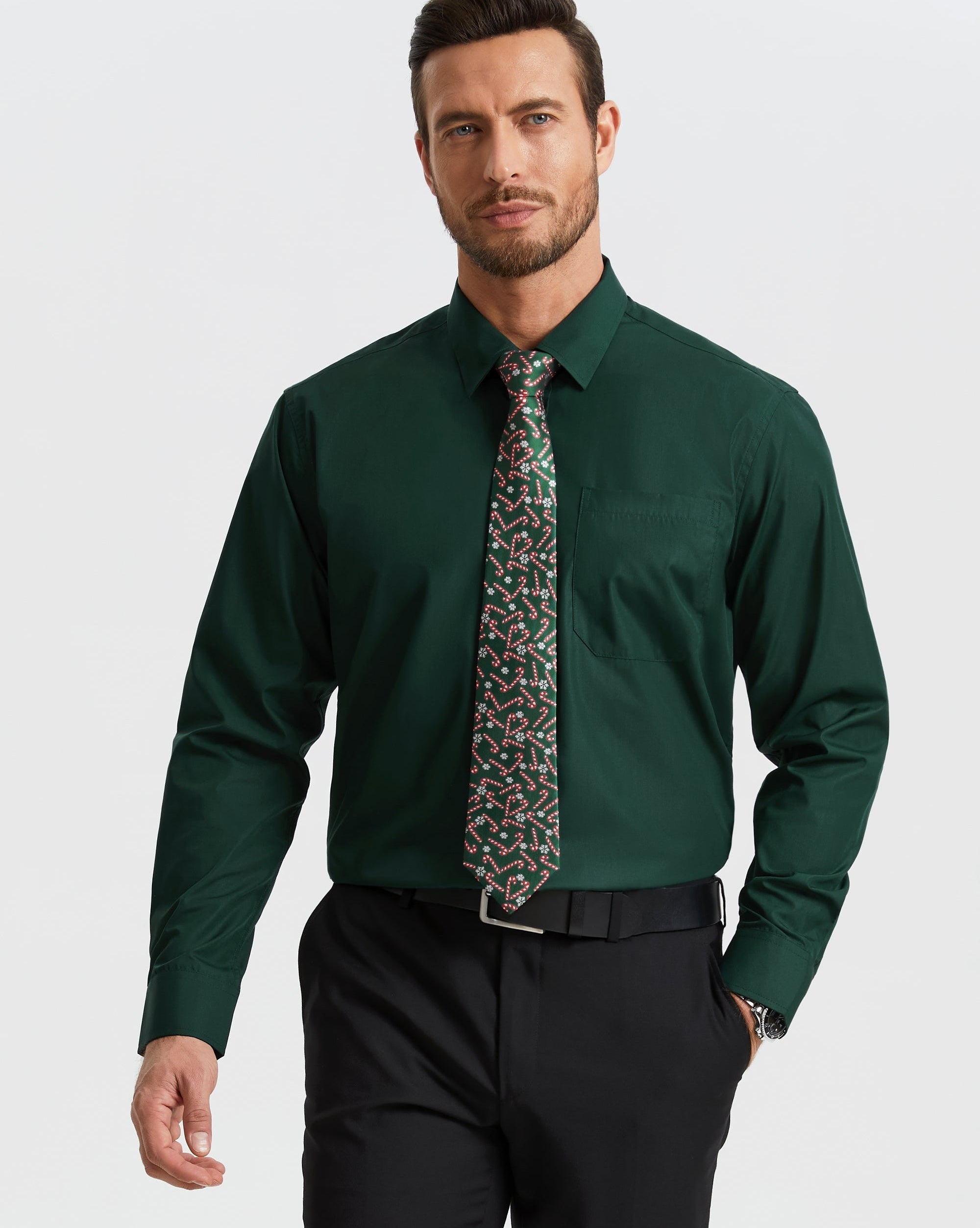 Man wearing a green dress shirt with a patterned tie against a white background